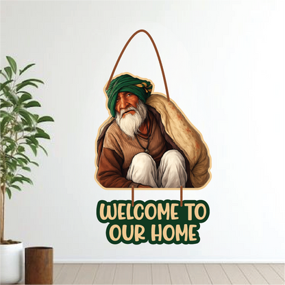 Decorative wall hanging with a man in traditional attire and 'Welcome to our home' text, placed indoors.